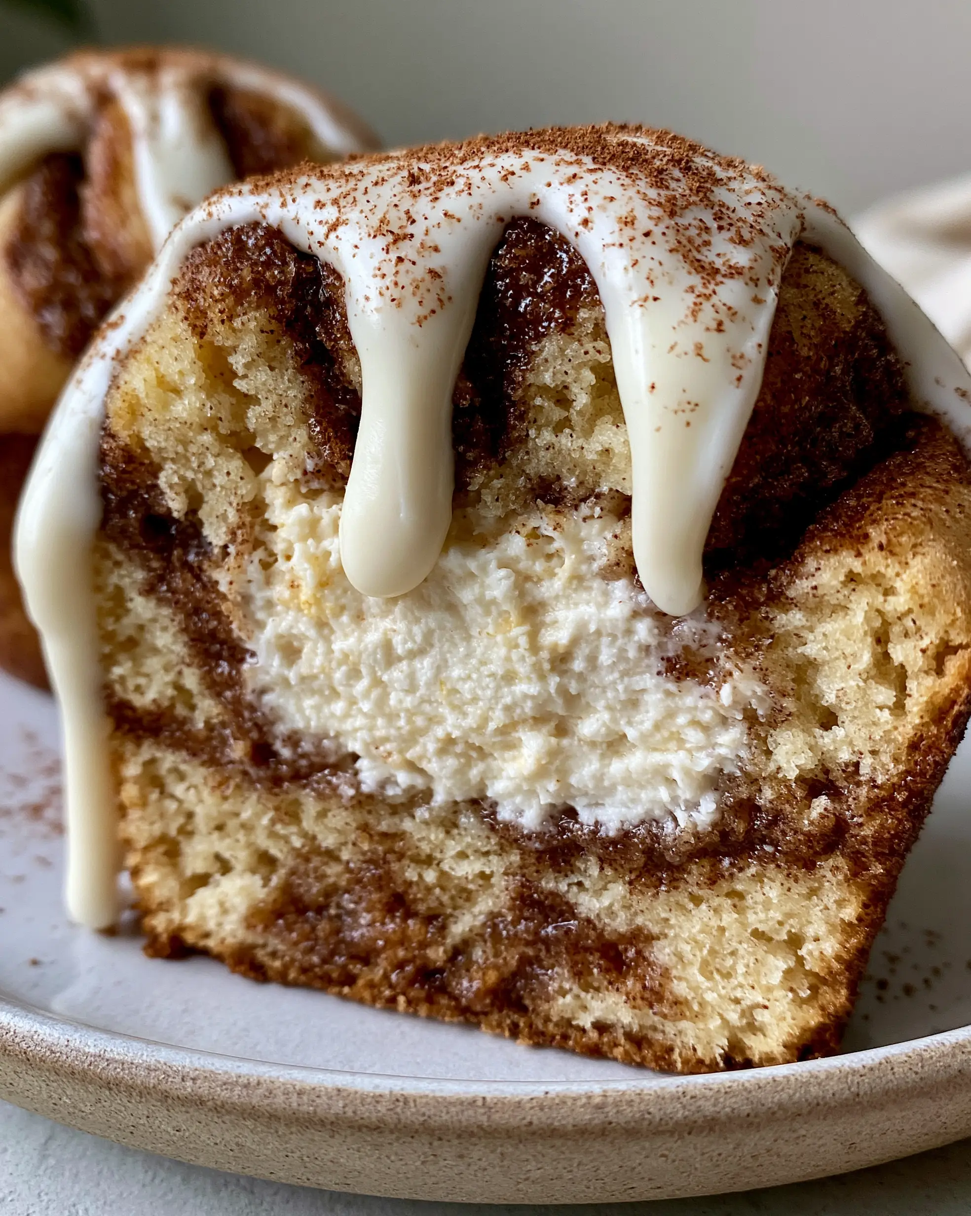 Ultra close-up of Zimt Cheesecake Muffins sliced in half showing the creamy cheesecake core and cinnamon swirls.