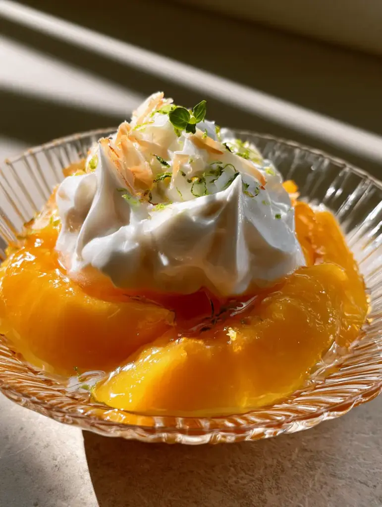 Detailed view of the airy bubbles in the coconut cream and the toasted coconut shards on the Peach & Coconut Cream.