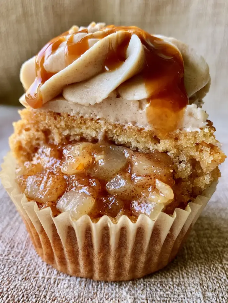 Authentic smartphone photo of a gourmet apple pie cupcake in a textured paper liner. (Apple Pie Cupcakes)